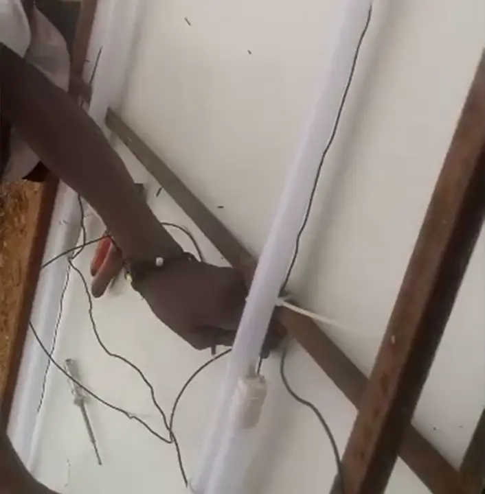 LED tube wiring close-up during Ability Pharmacy signage installation