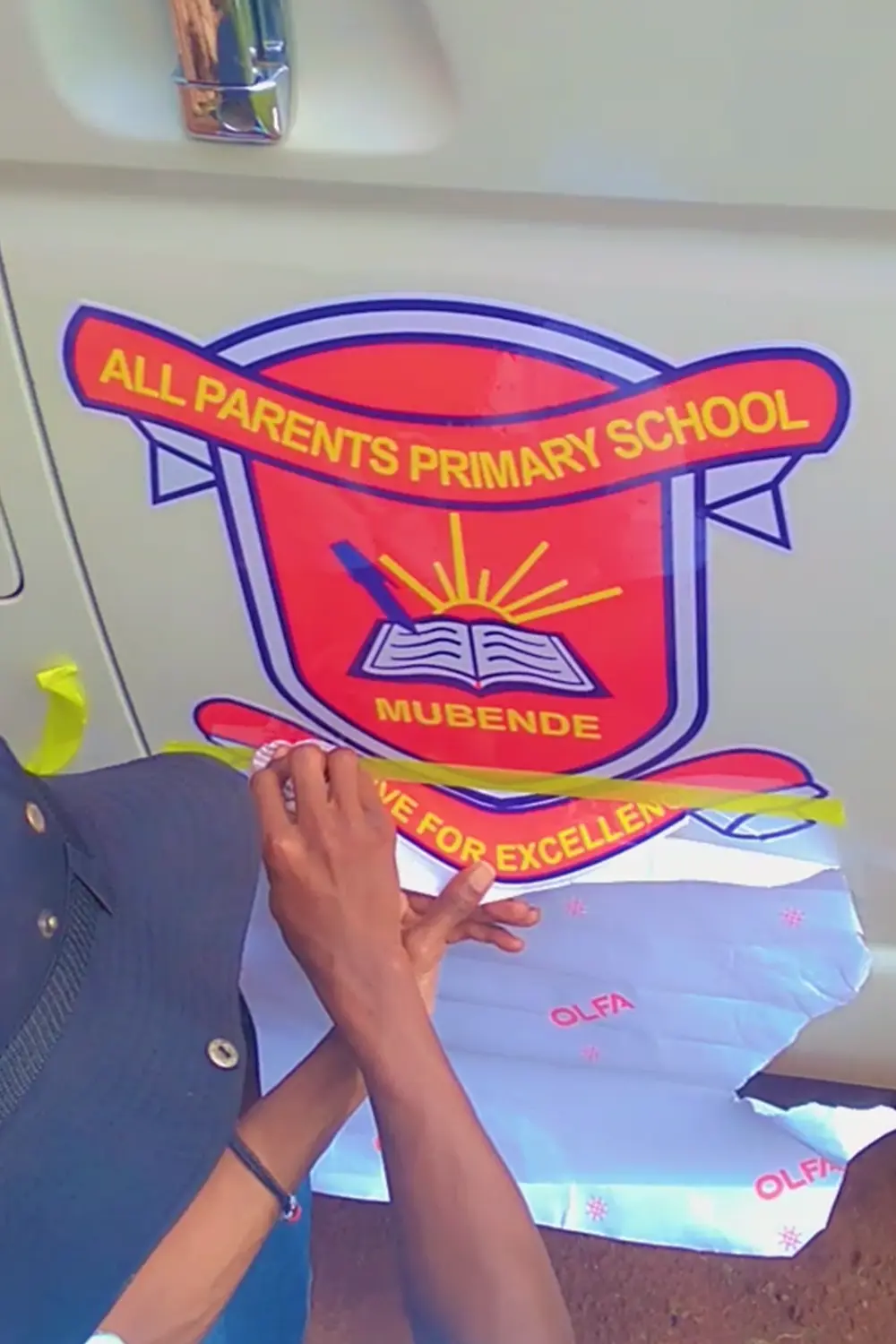 School logo detail installation on vehicle branding project