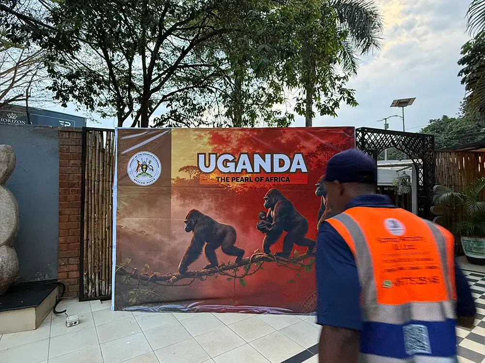Kamog Artistry installer inspecting the completed tourism event backdrop during same-day setup at The Lawns Restaurant