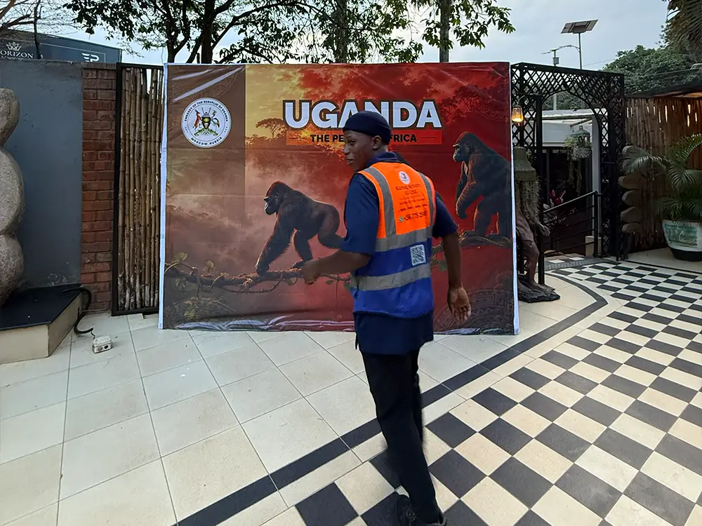 On-site inspection of the installed Feliz Tropical Safaris Uganda tourism backdrop before the reception in Kololo