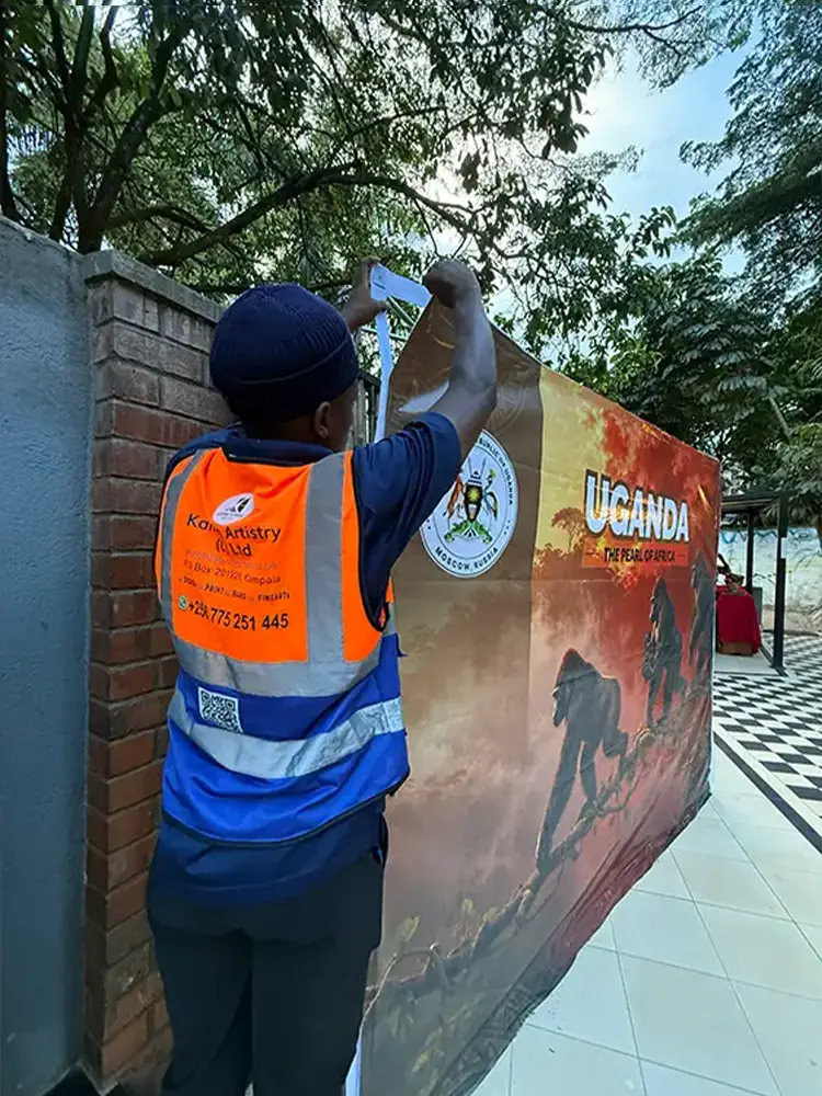Large-format printed event artwork being fitted and stretched onto the display structure at The Lawns Restaurant