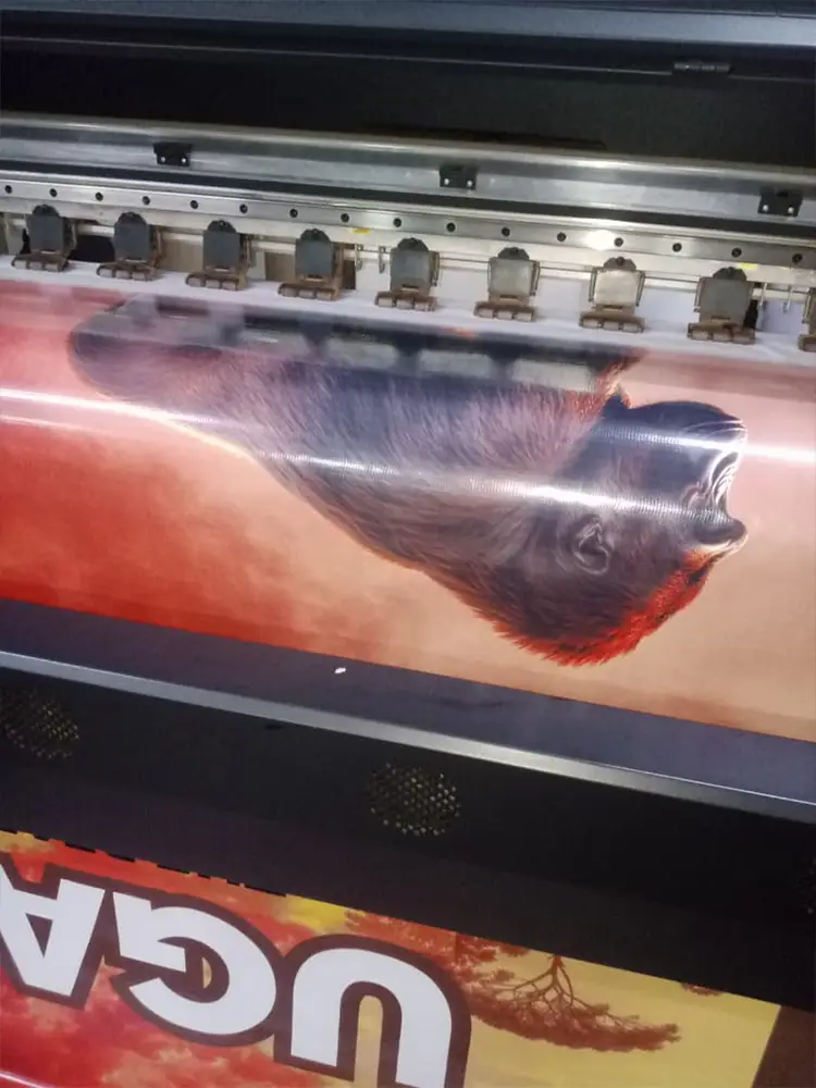 Uganda tourism backdrop artwork printing on a large-format machine during urgent same-day production in Kampala