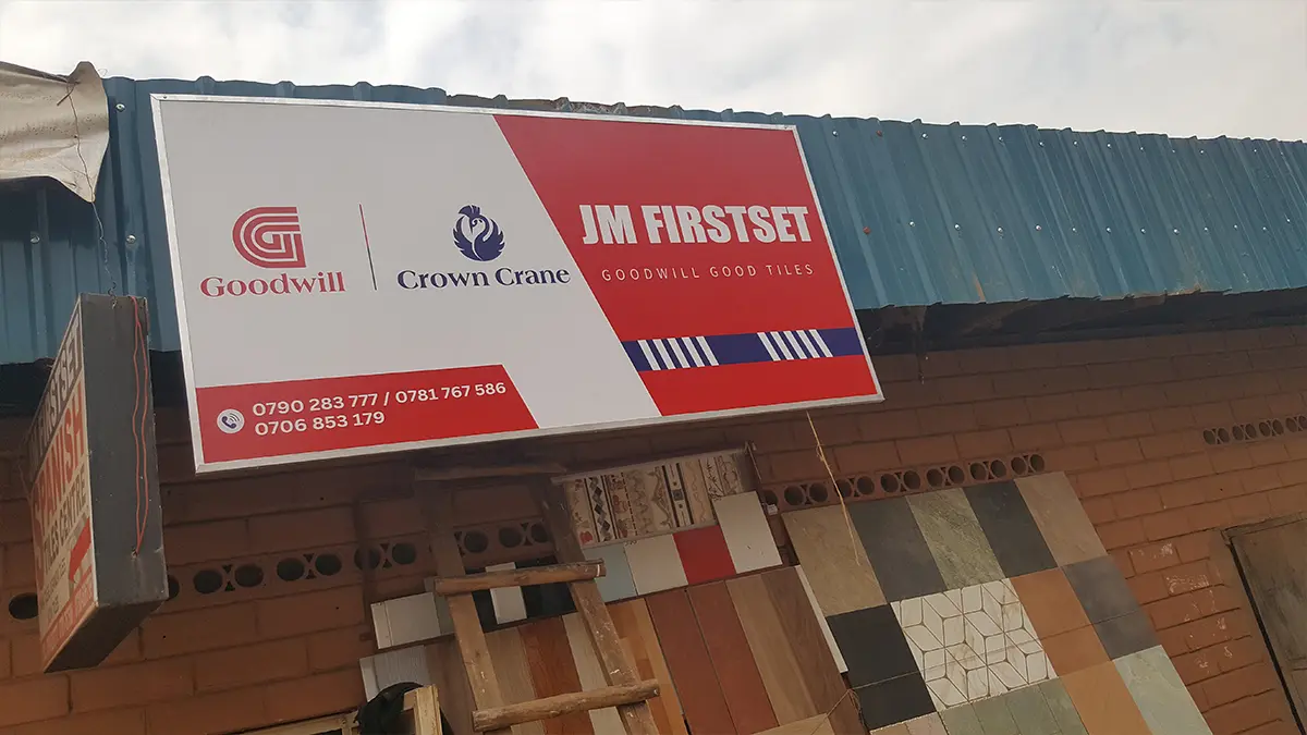 Installed sign holding above the Kampala frontage at JM Firstset • Sixth Street for the Goodwill and Crown Crane rollout