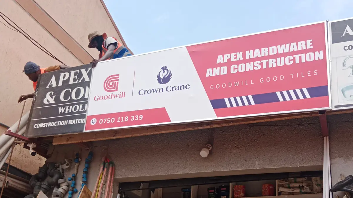 Mounting underway on the hardware-front structure at Apex Hardware • Namuwongo for the Goodwill and Crown Crane rollout