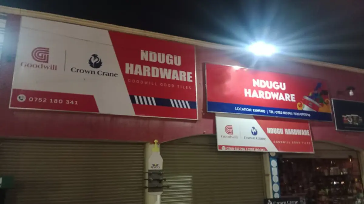 Completed signage photographed during the night run at Ndugu Hardware • Kawuku for the Goodwill and Crown Crane rollout