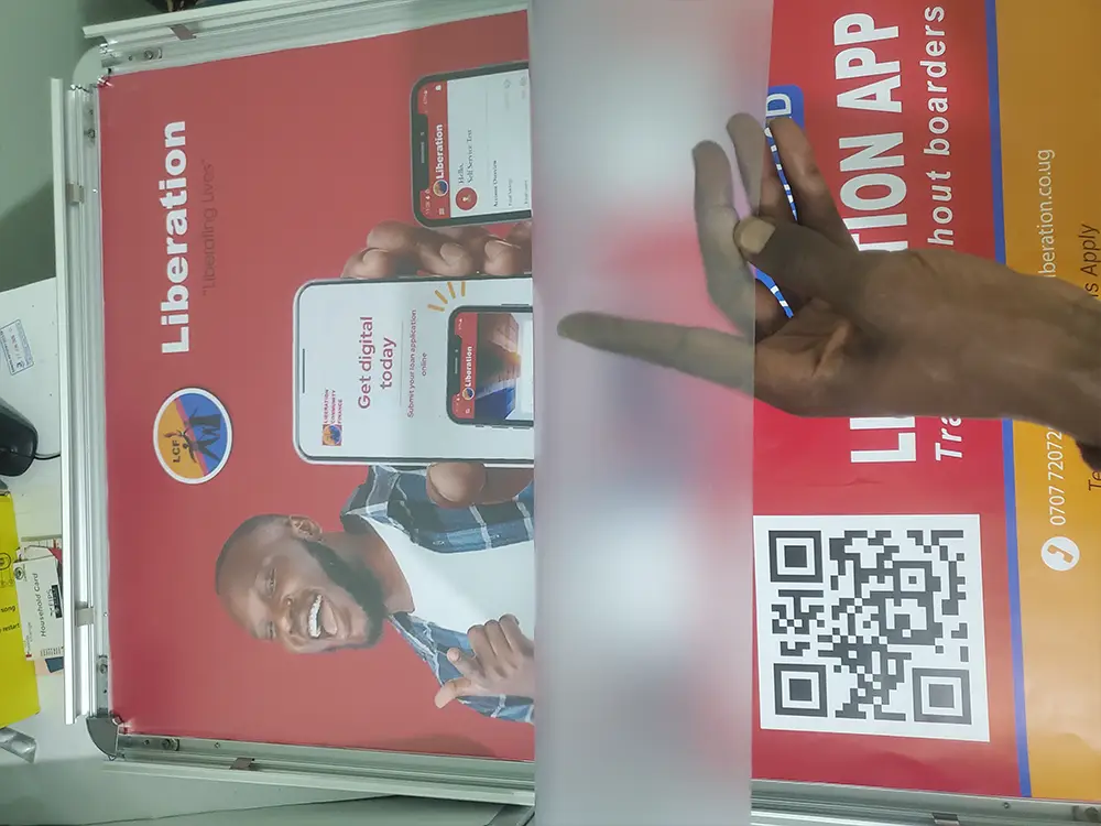Protective sheet placed over fitted Liberation App artwork while the QR code remains clear and visible.