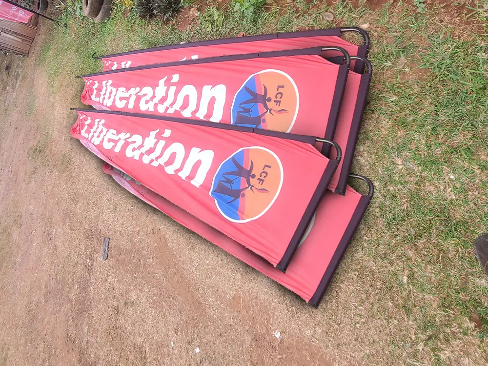 Liberation Community Finance teardrop banners prepared on site for installation at Namirembe.