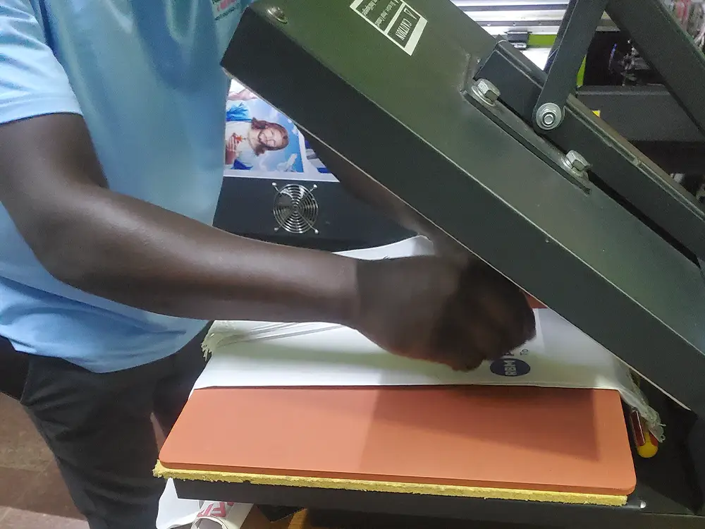 Applying branding to conference scarves from RBM Partnership to End Malaria event branding case study by Kamog Artistry (U) Ltd