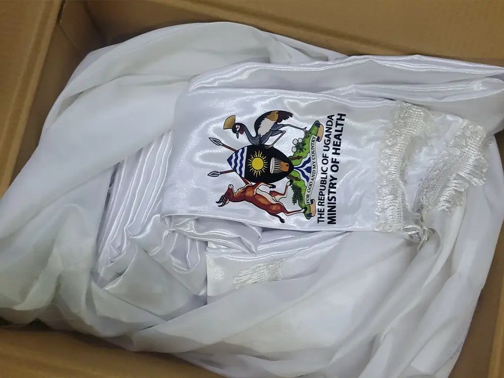 Completed scarves ready for conference use from RBM Partnership to End Malaria event branding case study by Kamog Artistry (U) Ltd