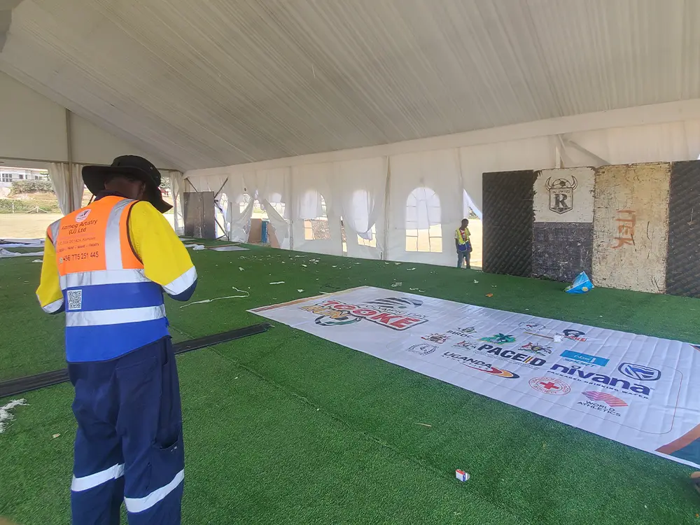 Large format sponsor backdrop PVC print — sponsor large PVC backdrop banner laid on the ground before installation for event visibility.
