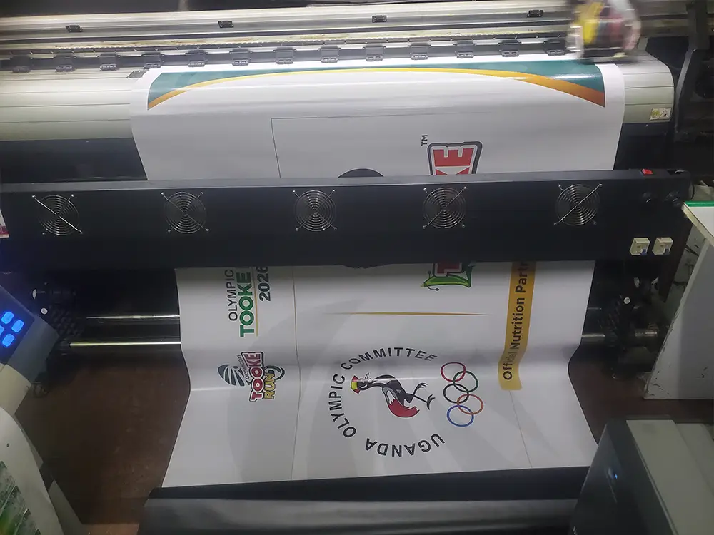Field barrier banner output — Large format machine printing the 1.2m × 1.8m PVC banners prepared for field barriers.