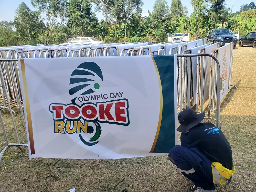 Field barrier banner installation — PVC banner fixed onto an individual field barrier using eyelets and field installation materials.
