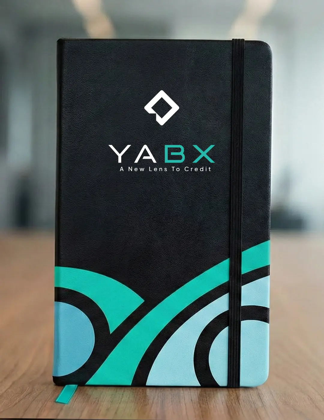 Branded corporate notebook with YABX logo used in custom merchandise gift pack produced by Kamog Artistry in Kampala