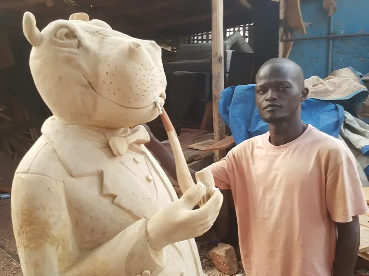 Bobby Otto beside Gentleman Hippo sculpture during Kampala studio visit