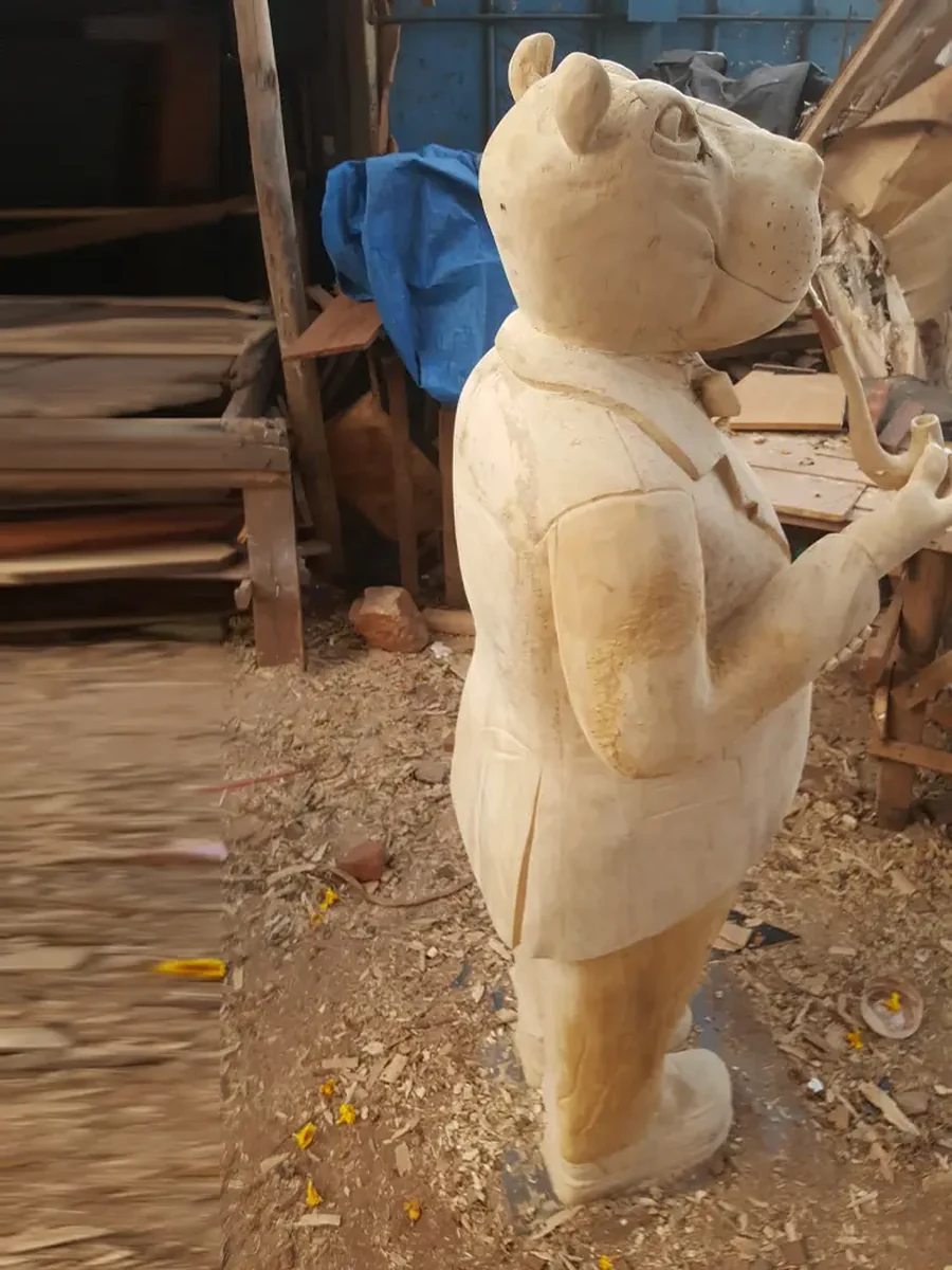 Back and side view of Gentleman Hippo sculpture showing carving stage